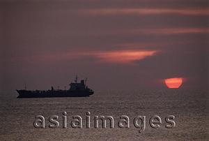 Asia Images Group - Vietnam, Vung Tau, oil tanker in the South China Sea at sunset.