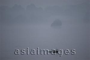Asia Images Group - Vietnam, Halong Bay, lone boat in the mist.