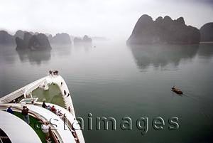 Asia Images Group - Vietnam, Halong Bay, cruise ship and small fishing boat.