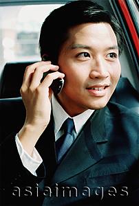 Asia Images Group - Male executive in car, talking on cellular phone