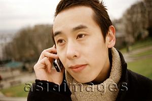 Asia Images Group - Man outdoors using cellular phone.