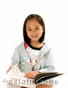 Asia Images Group - Young girl with book, white background.