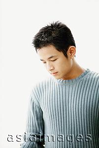 Asia Images Group - Man in blue sweater, white background