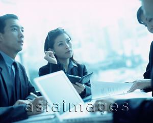 Asia Images Group - Female executive using PDA , male executive next to her.