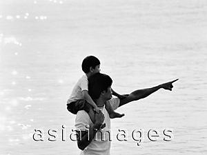 Asia Images Group - Father and son at beach, son on father's shoulders