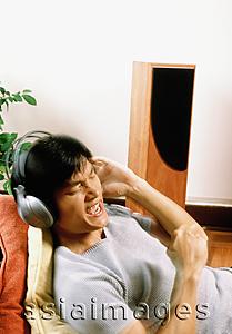 Asia Images Group - Man listening to headphones