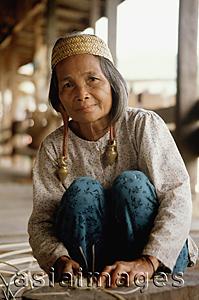 Asia Images Group - Malaysia, Sarawak, Kenya woman splitting rattan
