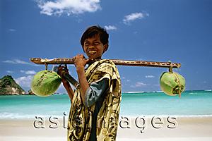Asia Images Group - Indonesia, Lombok, boy selling coconuts on beach