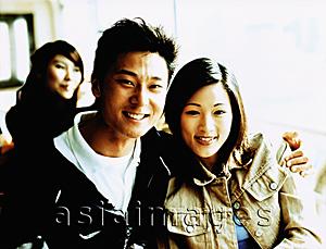 Asia Images Group - Young man with arm around woman, portrait.