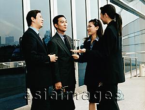 Asia Images Group - Executives meeting outside building.