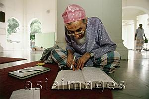 Asia Images Group - Malaysia, Penang, Muslim scholar studies Islamic histories at Kapitan Kling Mosque.