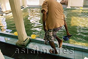 Asia Images Group - Malaysia, Penang, Indian Muslim washing his feet in a ritual of ablution before prayers at the Kapitan Kling Mosque.