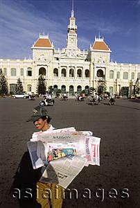 Asia Images Group - Vietnam, Ho Chi Minh City, A man selling newspapers on the street.