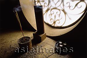 Asia Images Group - Vietnam, Incense burning by window.