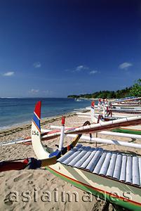 Asia Images Group - Indonesia, Bali, Sanur Beach, Fishing boats (Jukung) lined up on beach. (grainy)