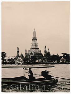 Asia Images Group - Thailand, Bangkok, Chao Phraya River, Long tail boat on river, Wat Arun Temple in background. (artistic grain)