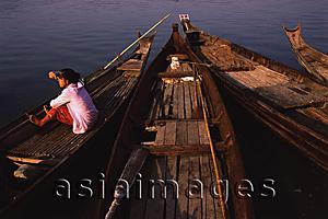 Asia Images Group - Myanmar (Burma), Pyay, Woman waiting on canoe on the Irrawaddy river.