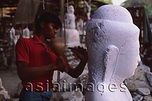 Asia Images Group - Myanmar (Burma), Mandalay, Stone mason carving Buddha statue.