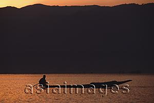 Asia Images Group - Myanmar (Burma), Inle lake, Silhouette of fisherman in canoe at sunrise.