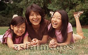 Asia Images Group - Mother and two daughters lying on grass