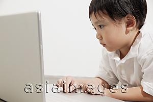 Asia Images Group - Young boy using laptop