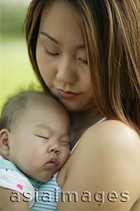 Asia Images Group - Mother carrying sleeping baby