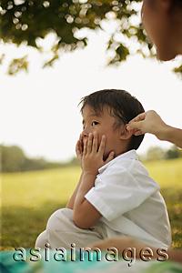 Asia Images Group - Young boy with hands on his face