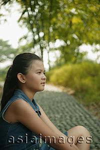 Asia Images Group - Young girl sitting down, profile