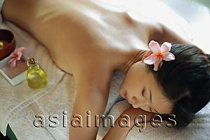 Asia Images Group - Young woman lying on massage table, eyes closed