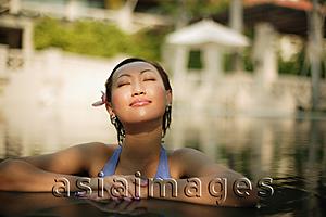 Asia Images Group - Young woman, at edge of swimming pool