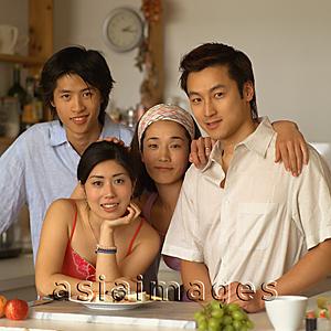 Asia Images Group - Friends in kitchen, looking at camera