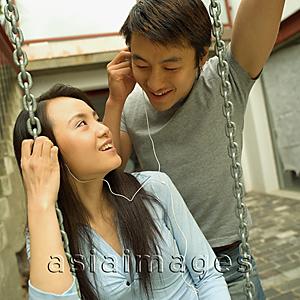 Asia Images Group - Couple listening to personal stereo