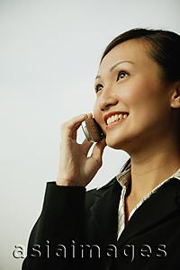 Asia Images Group - Young woman on mobile phone, smiling