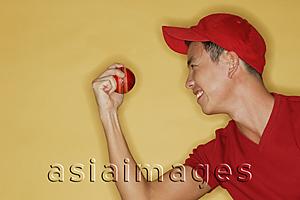 Asia Images Group - Young man holding a ball, side view