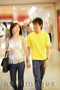 Asia Images Group - Couple walking hand in hand in store