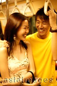 Asia Images Group - Couple standing in subway train