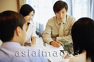 Asia Images Group - Young executives, having a meeting.