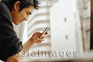 Asia Images Group - Young man using mobile phone