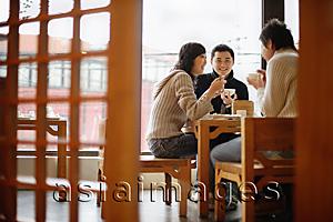 Asia Images Group - Young couples at a Chinese restaurant, low angle view