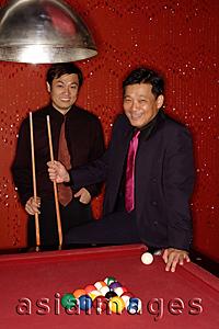 Asia Images Group - Two businessmen at pool table