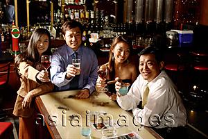 Asia Images Group - Couples raising wine glasses, looking at camera