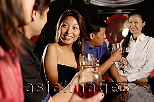 Asia Images Group - Men and women at bar, drinking