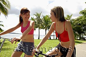 Asia Images Group - Two women on bicycles, side by side
