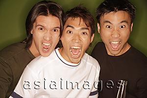 Asia Images Group -  Three young men, shouting, looking at camera