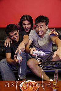 Asia Images Group - Young men at home playing with video games