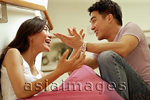 Asia Images Group - Couple facing each other, hands raised