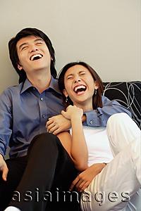 Asia Images Group - Man with arm around woman, laughing
