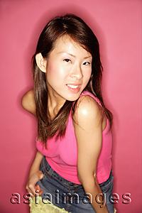 Asia Images Group - Young woman in pink top, looking at camera