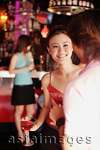 Asia Images Group - Couple holding drinks, talking