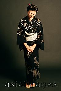 Asia Images Group - Woman in Japanese costume, standing, hands clasped